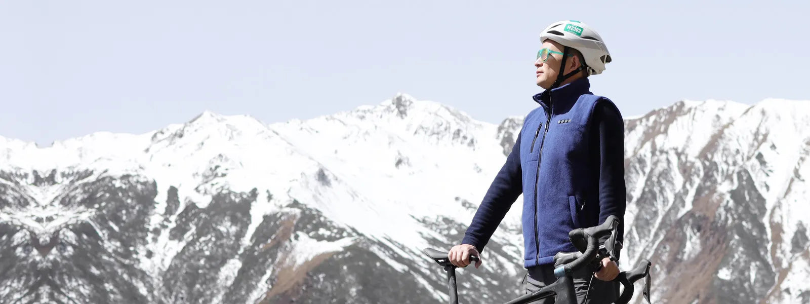 A man is wearing ARRIS heated fleece vest while riding